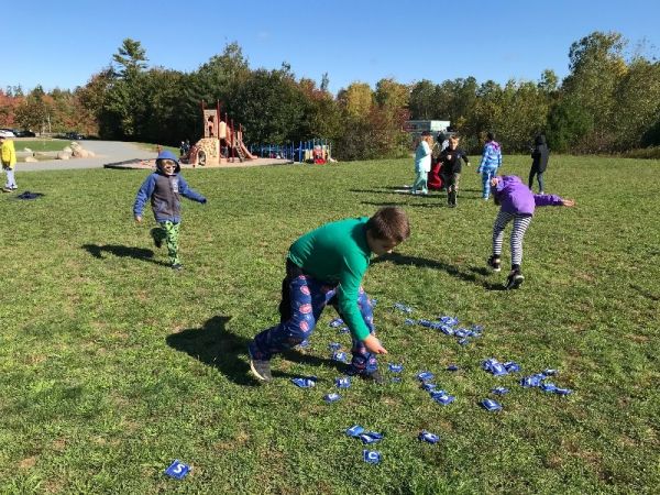 Children outside playing and learning words Children outside playing and learning words